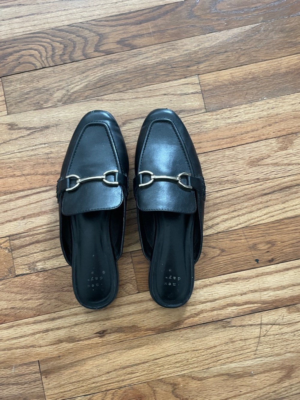 Black mules with gold buckle